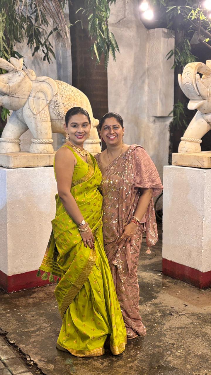 Two community members in festive sarees
