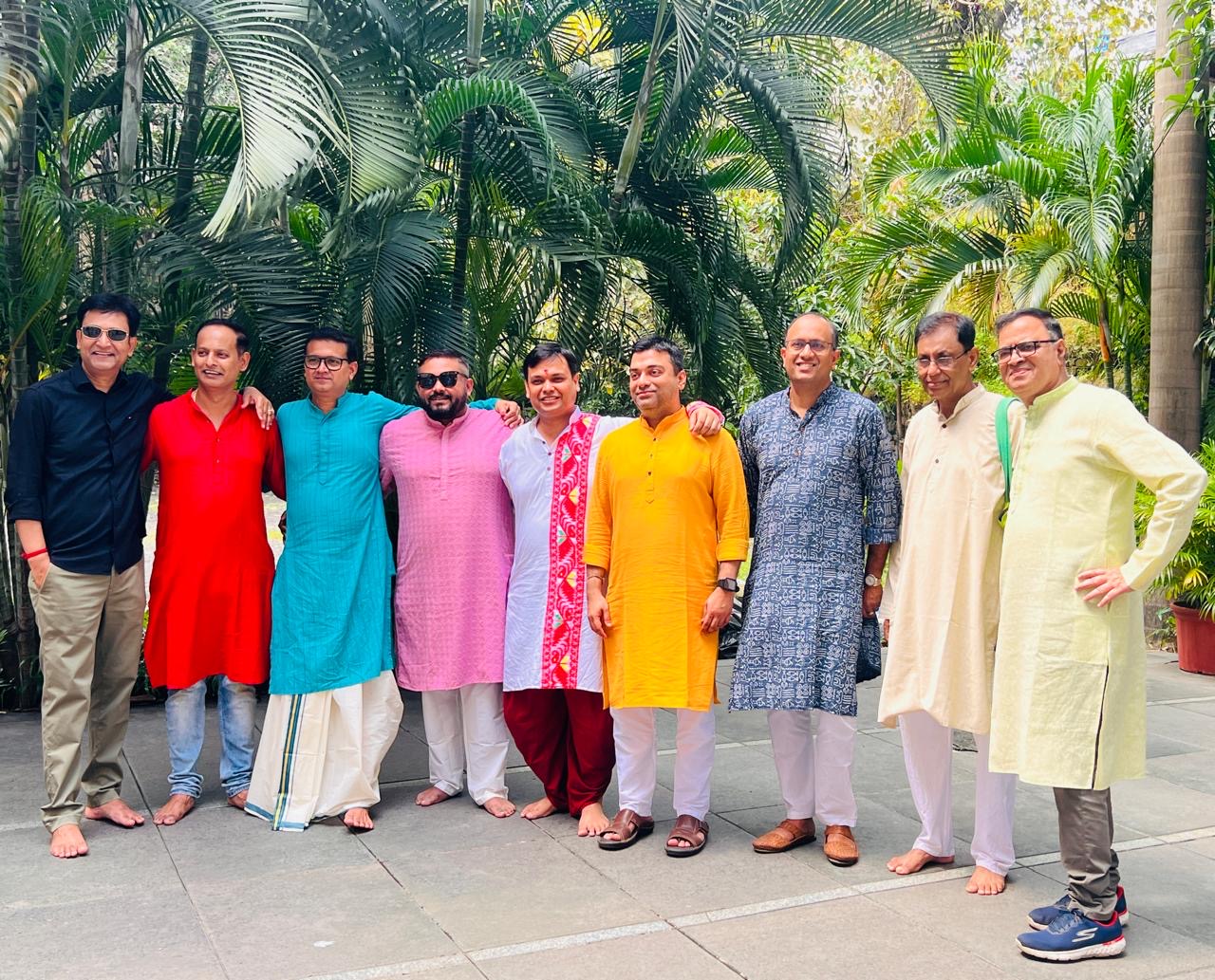 Members of the Marol Pujo team standing together in colourful traditional attire in 2025